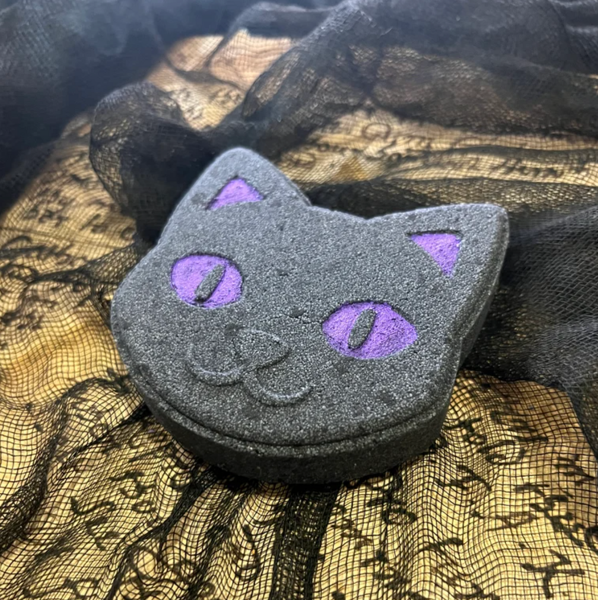 Spooky Season Bath Bombs in a cat shape, featuring gray and purple colors, perfect for Halloween relaxation.