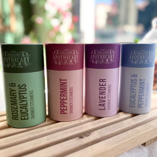 Shower Steamer 5 Pack in colorful gift tube featuring rosemary, eucalyptus, peppermint, and lavender scents.